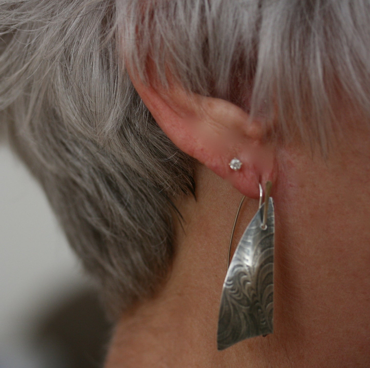 Textured dangly earrings modeled, image