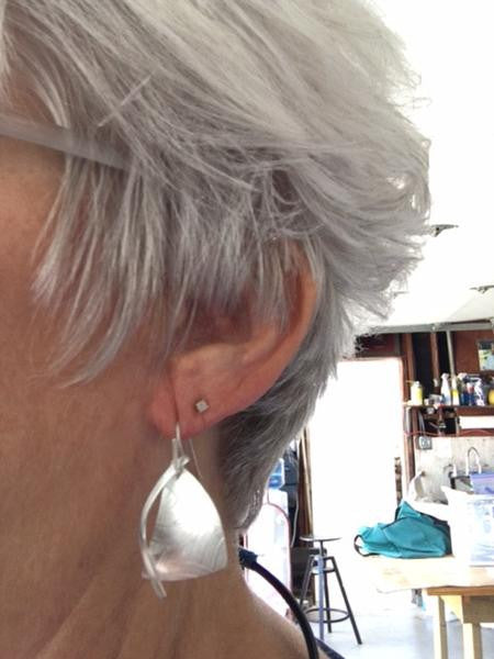 Textured dangle sterling silver earrings, modeled image