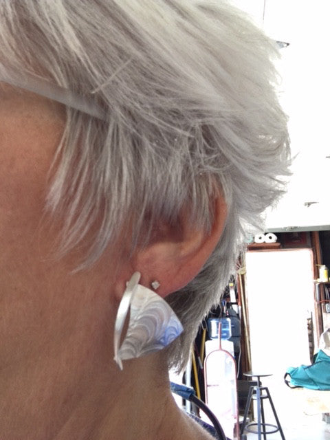 Silver wavy sailboat earrings modeled, image